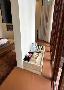 a room with a tray of food on a table at De Pointé Resort & Resto in Campaka