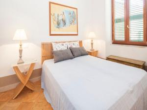 a bedroom with a large white bed and two lamps at Amalfi 2 rooms 1fl no terrace 2fl private terrace sea view in Atrani +47 photos
