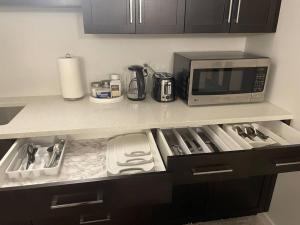 a kitchen counter with a microwave and appliances on it at Tanager Place in Winnipeg