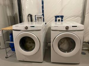 two washing machines sitting next to each other in a room at Tanager Place in Winnipeg +8 photos