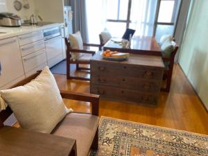 a kitchen and living room with a couch and a table at toya町家-chitose in Toyama
