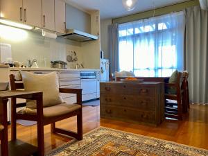 a kitchen with a table and a dining room at toya町家-chitose in Toyama