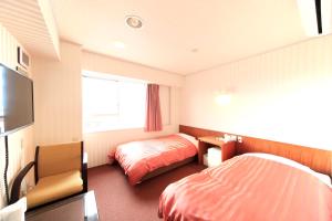 Postel nebo postele na pokoji v ubytování Nagano Daiichi Hotel