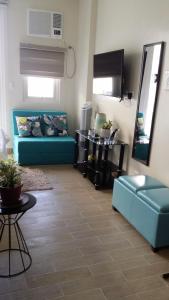 a living room with a blue couch and a table at megaworld iloilo city, one madison luxury residences in Iloilo City