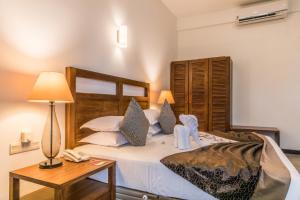 Postelja oz. postelje v sobi nastanitve Manthila Hotel