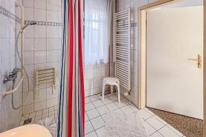 a bathroom with a shower and a shower backdoor at Villa Viktoria Whg 5 - "Moosmuschel" in Kolpinsee +6 photos