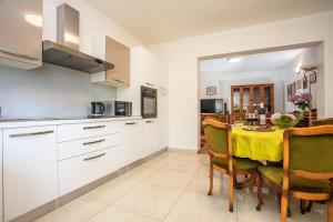 a kitchen and dining room with a table and chairs at Villa Knez in Gata