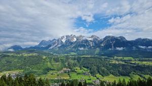 a view of a mountain range with a town and trees at Posers Bergwelt B&B in Schladming