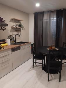 a kitchen with a black table and a table and chairs at Max in Vodice