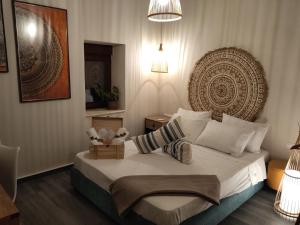 a bedroom with a bed with a large headboard at Pasiphae Luxury House in Ierapetra
