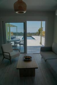 a living room with a couch and a table at MENTOROS VILLAS in Karavadhos