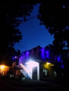 a house with blue lights on top of it at night at New Samanali Resort in Kataragama