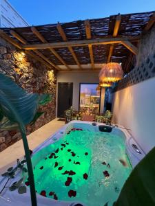 a jacuzzi tub in the middle of a room at City Compass Luxury Suites Faliraki in Faliraki
