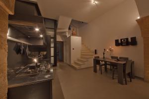a kitchen and dining room with a table and a staircase at Zenthe Small Luxury B&B and Yoga in Brindisi