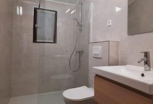 a bathroom with a shower and a toilet and a sink at Apartmani Maver in Sveti Filip i Jakov +92 photos