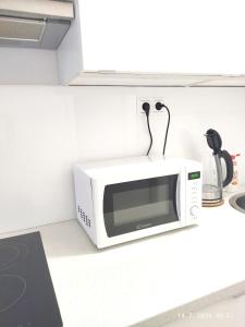 a microwave sitting on a counter in a kitchen at Garsónka v Bratislave in Bratislava