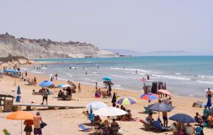 a group of people on a beach with umbrellas at Gorgeous Home In Realmonte With Kitchen in Realmonte +19 photos