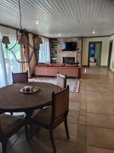 a living room with a table and a couch at Forest apartment in the loop of the river Neris in Verkšonys