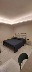 a bedroom with a bed and a chair in a room at La Scalinata Suite in Perugia