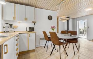 a kitchen and dining room with a table and chairs at Holiday Home Strandvejen Brovst Denm in Brovst