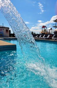 a water fountain in the middle of a swimming pool at Czar wakacji in Sarbinowo