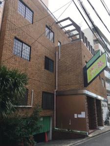 a brick building with a sign in front of it at 大阪グランドホテル Osaka Grand Hotel in Osaka