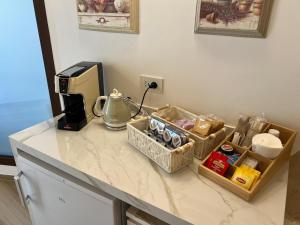 a kitchen counter with a coffee maker and food items at Carola Luxury Room in Bari