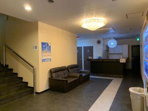 a waiting room with a leather chair and a bar at 大阪グランドホテル Osaka Grand Hotel in Osaka