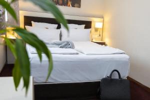 Postel nebo postele na pokoji v ubytování Hotel Nordhausen
