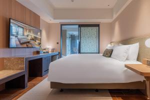 Ένα ή περισσότερα κρεβάτια σε δωμάτιο στο Kilin Hotel, JiaoXi