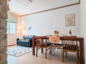 a living room with a table and chairs and a couch at 점미하우스 in Bucheon