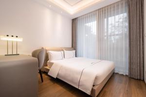 Posteľ alebo postele v izbe v ubytovaní Sanya Haitang Bay Muyu Time Seaview Apartment