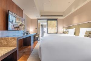 Ένα ή περισσότερα κρεβάτια σε δωμάτιο στο Kilin Hotel, JiaoXi