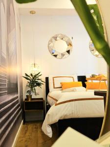 a bedroom with two beds and a mirror at Daily Napoli - Lungomare in Naples