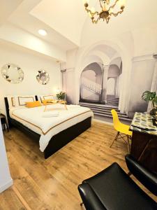a large bedroom with a large bed and a chandelier at Daily Napoli - Lungomare in Naples
