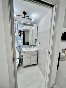 a bathroom with a sink and a mirror at A'MARE da Marco Loft in Sperlonga +4 photos