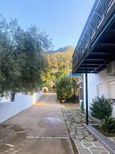 an empty street in front of a building at Blue Sky Apartments in Skala Potamias