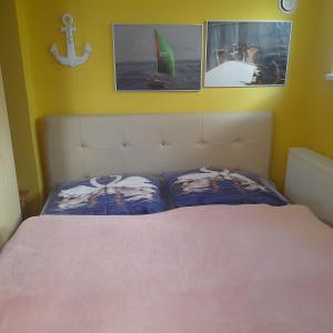 a bedroom with a bed with two pillows on it at Apartmán pod Magnóliou in Trenčín