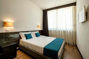 Postel nebo postele na pokoji v ubytování Hotel Cristallo