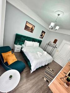 a bedroom with a bed and a chair in it at Vila Darli Peshkopi Dibra in Peshkopi