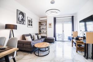 a living room with a couch and a table at Saranda Terraces Exclusive Appartment in Sarandë