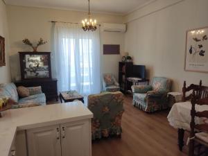 a living room with a couch and chairs and a table at Los Laureles A Relaxing Vintage Home in the Heart of Sparta in Sparta