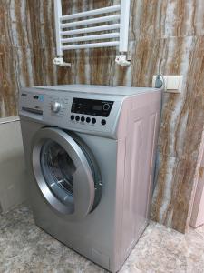 a washing machine in a bathroom with a window at Sayat-Nova Apartments Yerevan in Yerevan +5 photos