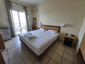 Postel nebo postele na pokoji v ubytování Vourvourou Hotel