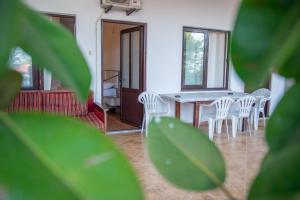a dining room with white chairs and a table at Ami Apartments in Ulcinj