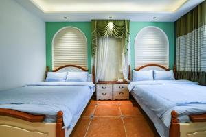 เตียงในห้องที่ Zhangjiajie Han Exotic Inn