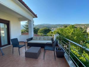 a patio with a couch and chairs on a balcony at SpitiAyia in Ayiá