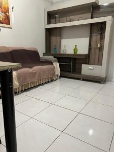 a bedroom with a bed and a tiled floor at Refúgio Serrano in Martins +4 photos