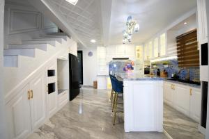a kitchen with white cabinets and a counter top at Casa de Monique Glamping Resort in Bogor