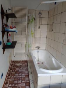 a bathroom with a tub and a tiled floor at casa vacanze marinela in Casarano +18 photos